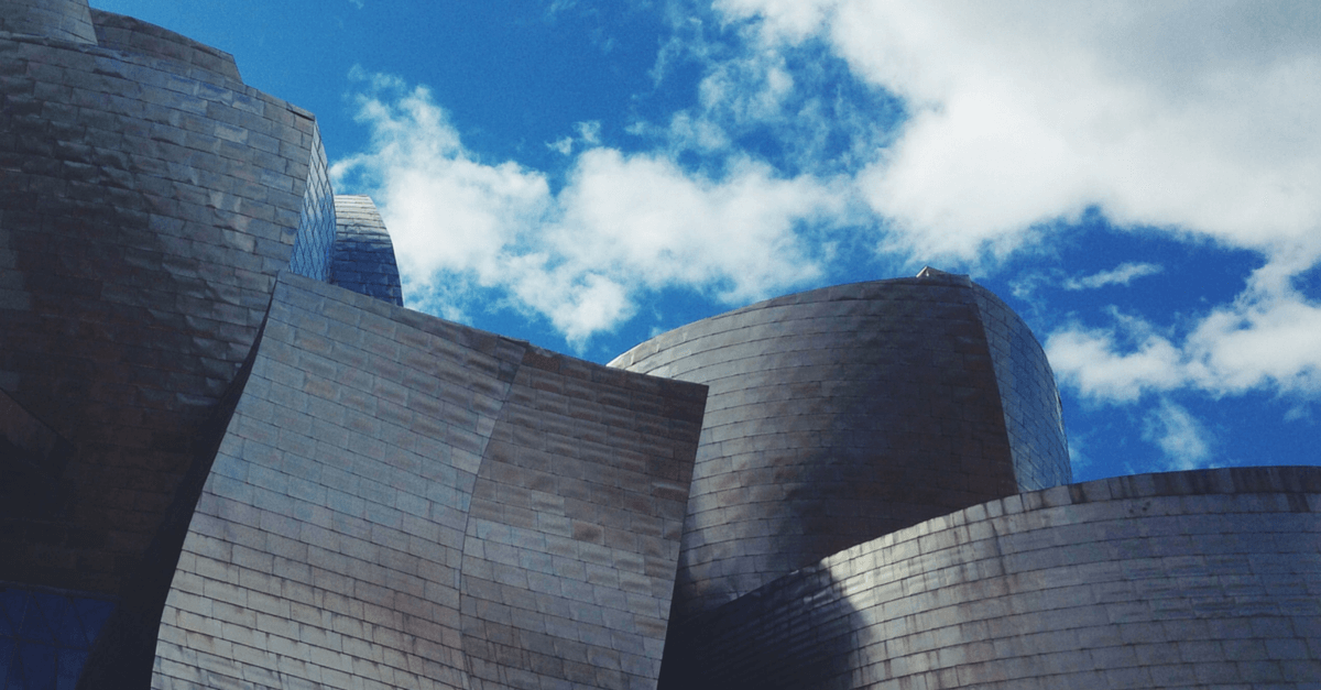 Unique, wavy architecture and a partly cloudy sky