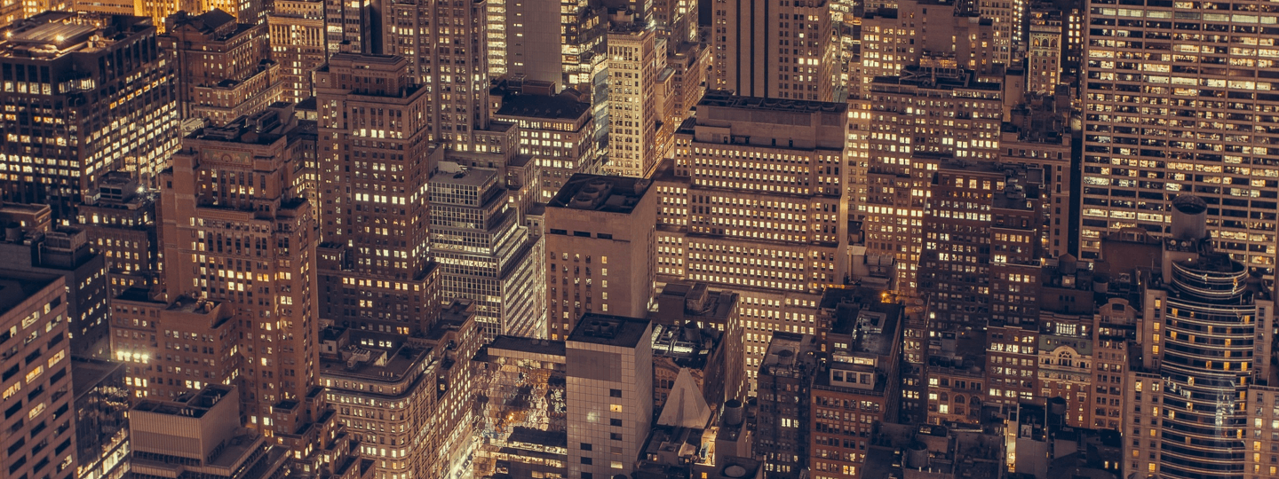 Aerial view down into an extremely dense, large city at night