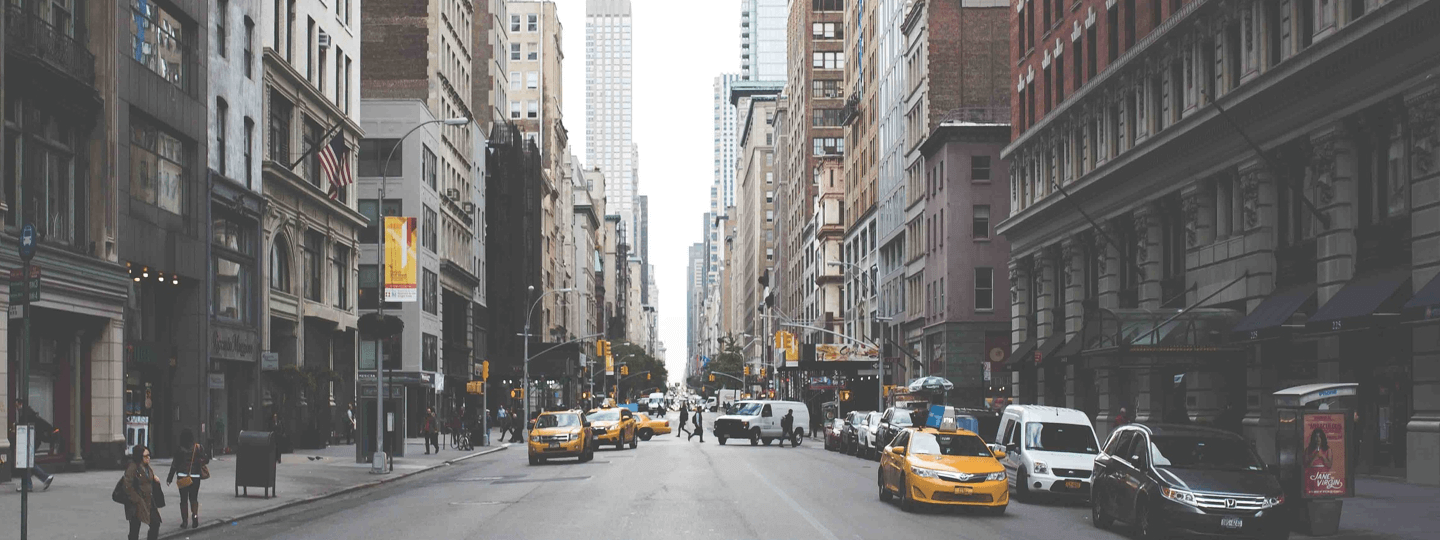 Looking down a street with several cabs in New York City