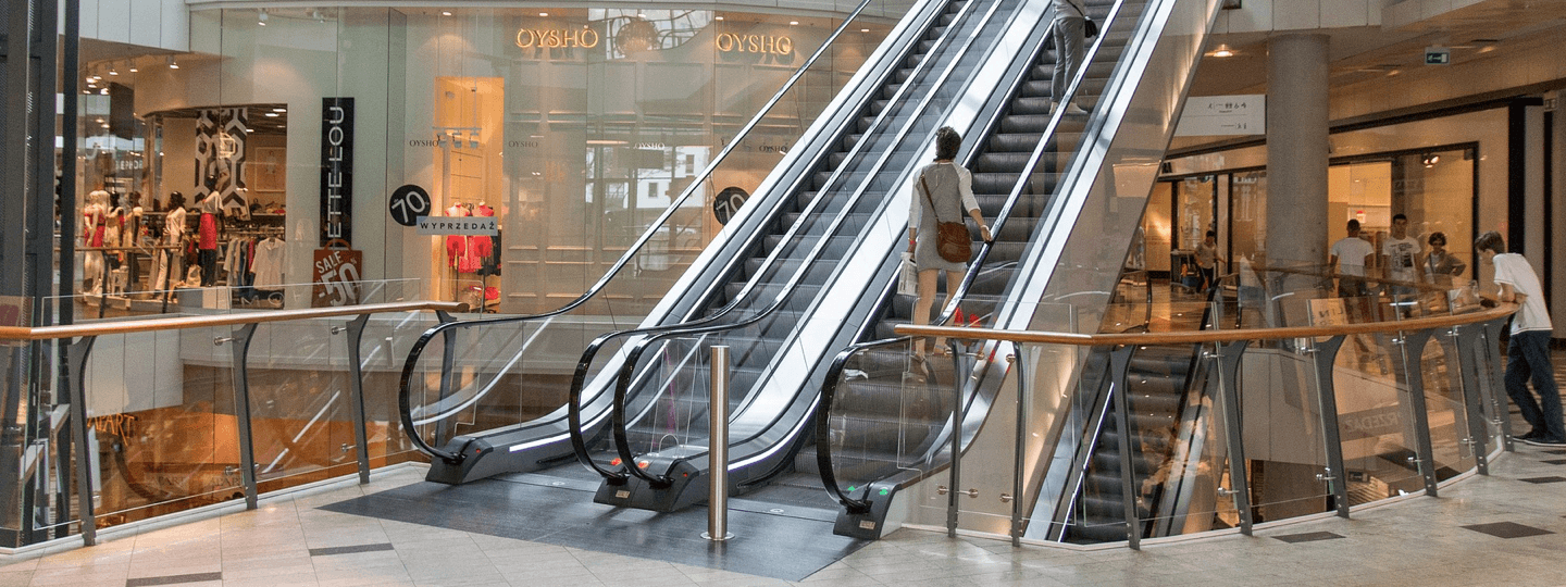 An escalator inside a multi-story mall