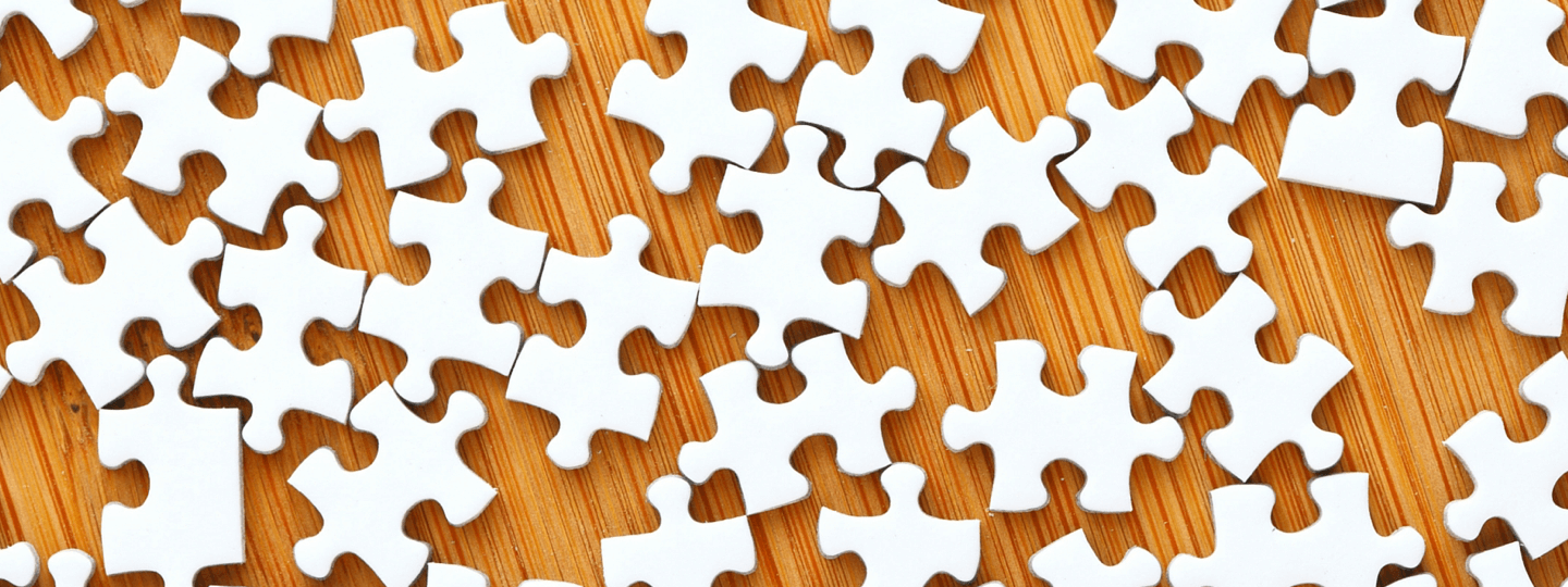 Blank puzzle pieces on a wood table