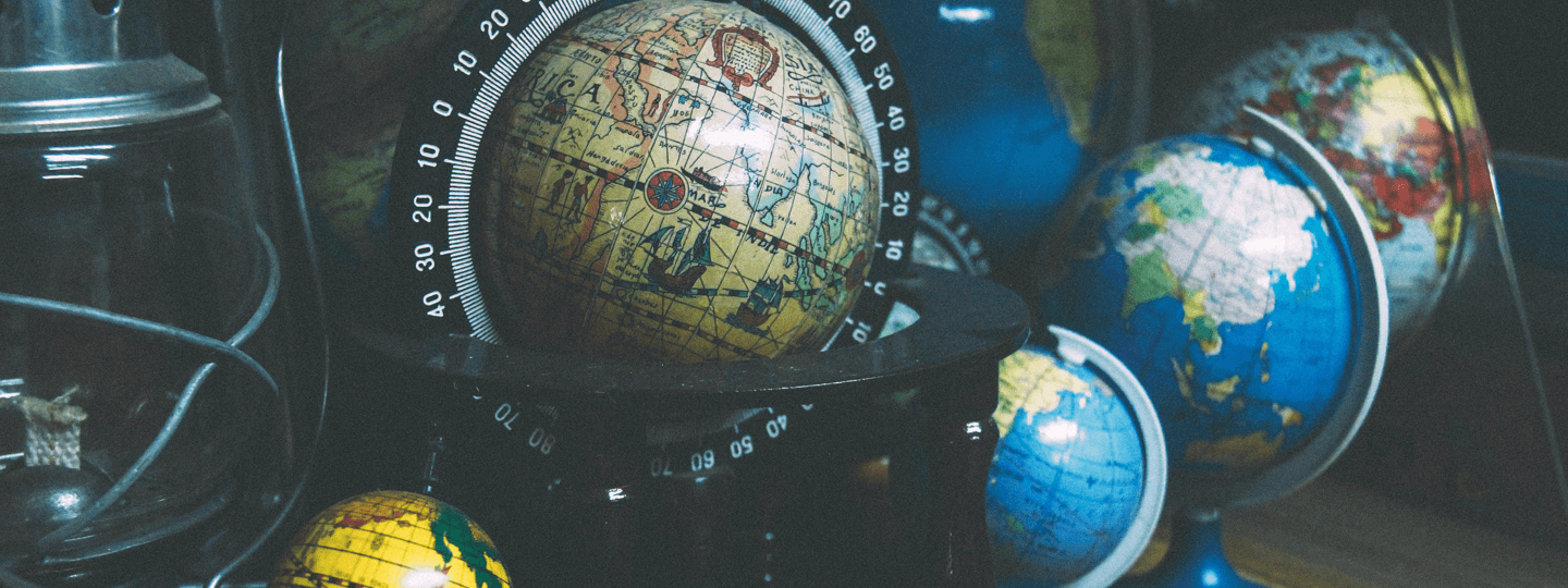 A collection of six globes and an old lantern