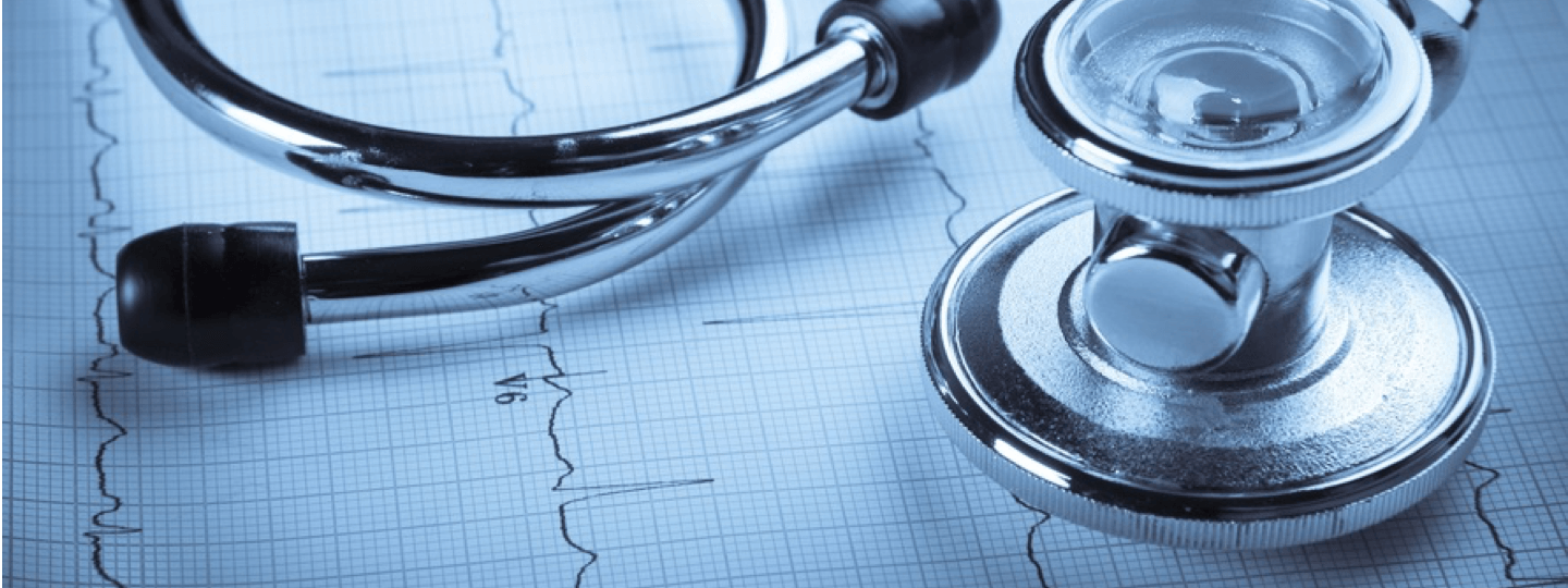 A stethoscope on top of an EKG chart