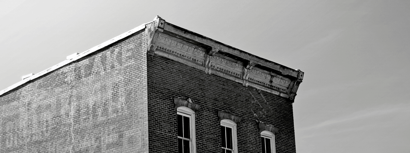 An old brick building with three windows