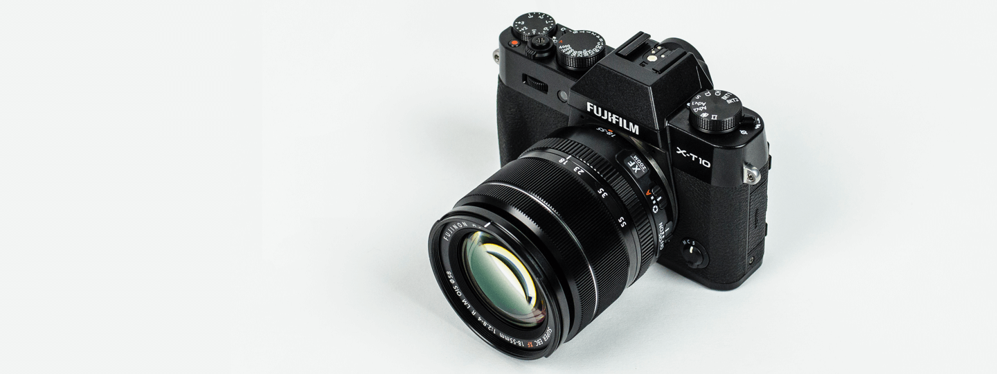 A Fujifilm X-T10 camera on a white background