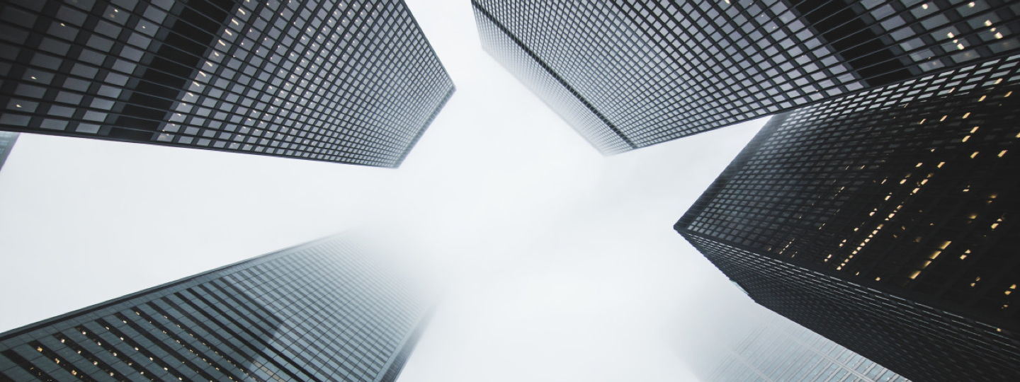 Looking up between 4 large high rise buildings