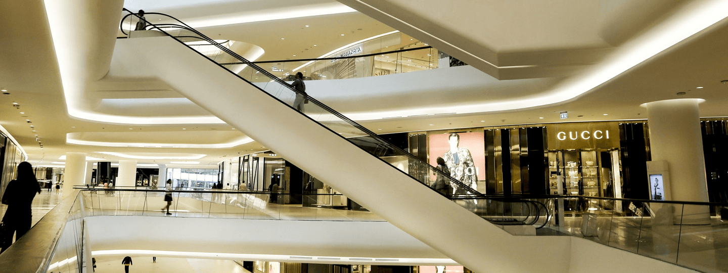 An escalator inside a multi-story mall