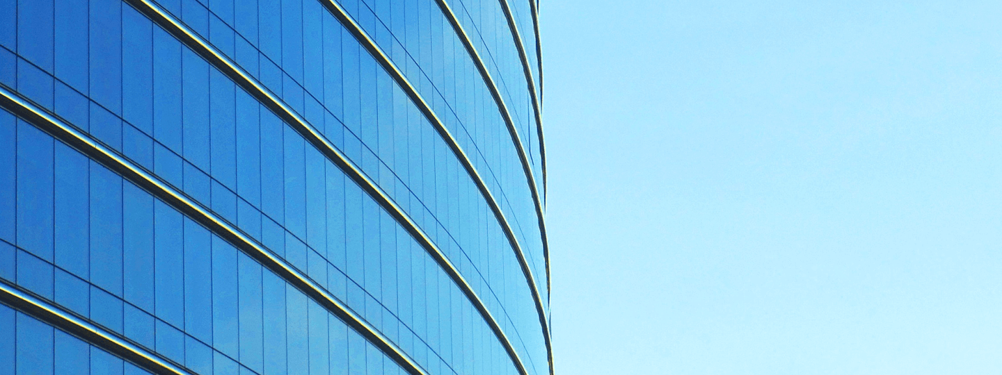 The side of a large, rounded office building