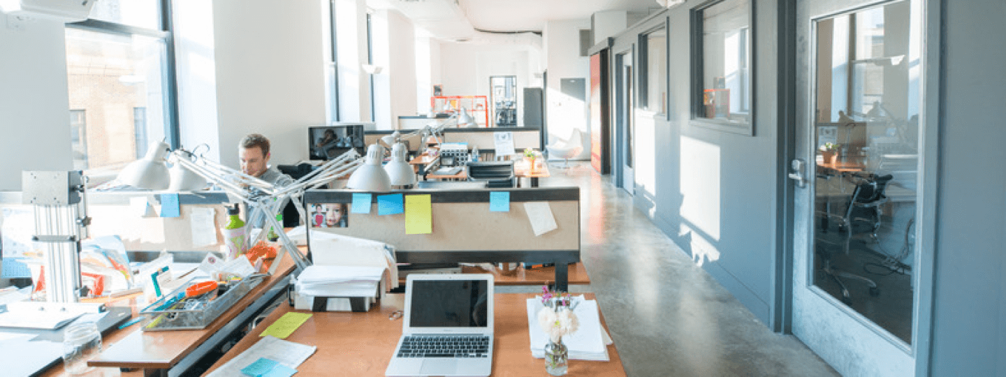 A single person working in a long, narrow office space