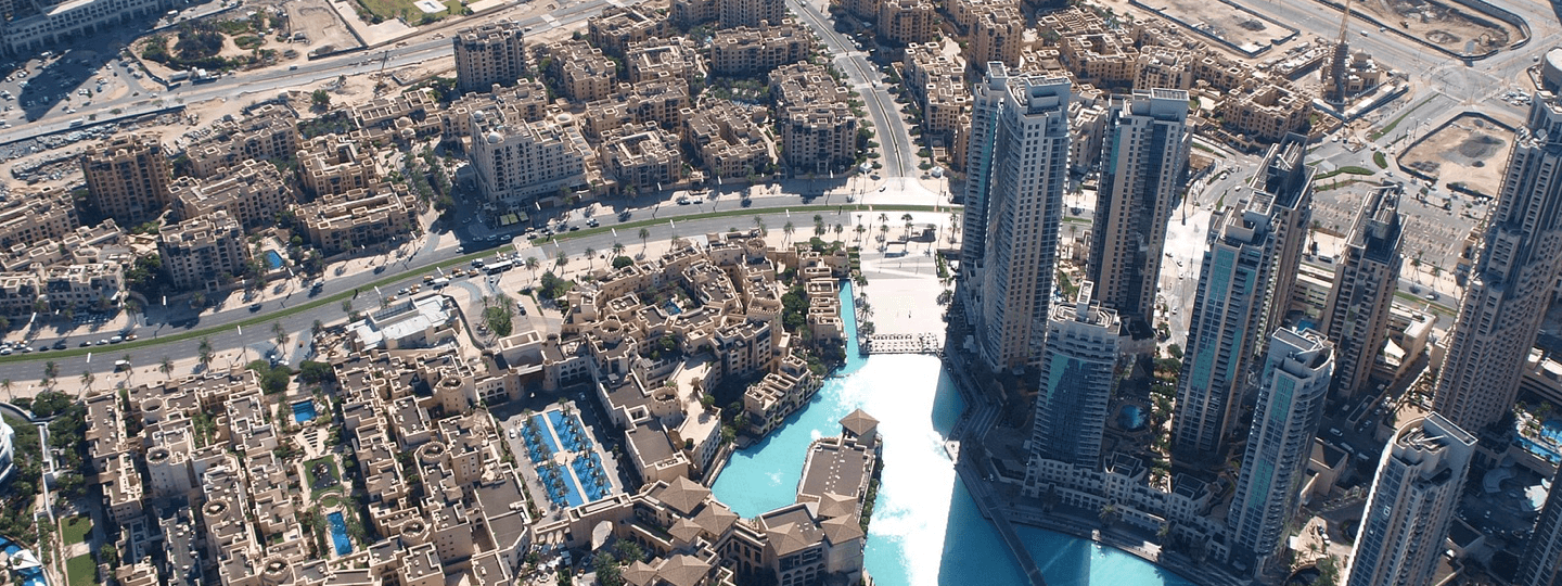 Aerial view of high rise buildings next to smaller buildings and a lake