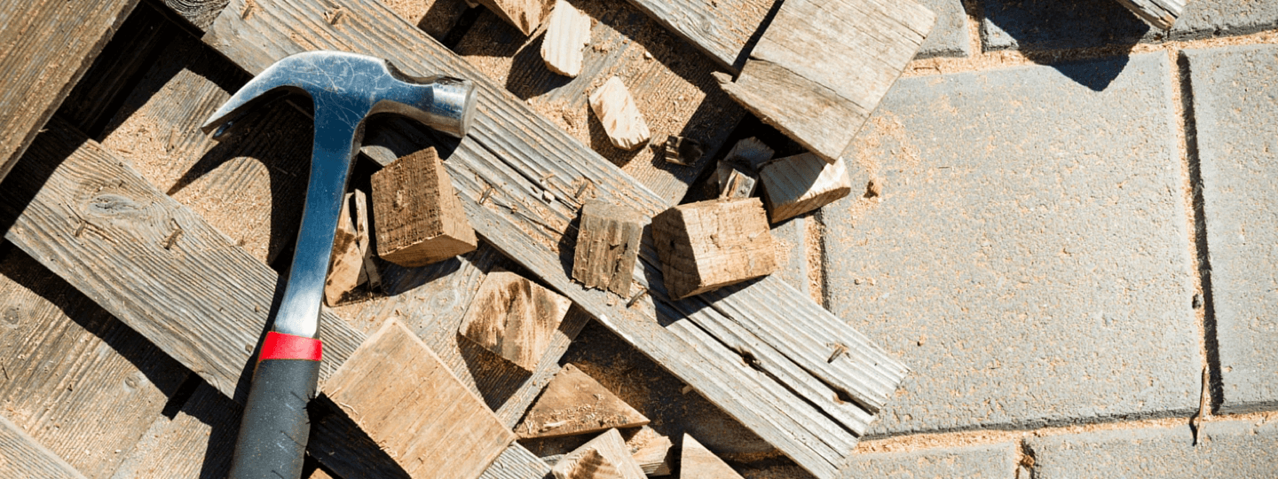 A hammer sitting on top of pieces of scrap wood