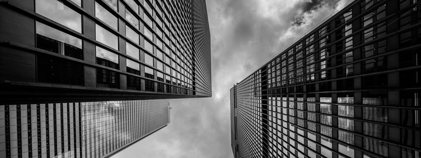 Looking up the sides of three tall office buildings