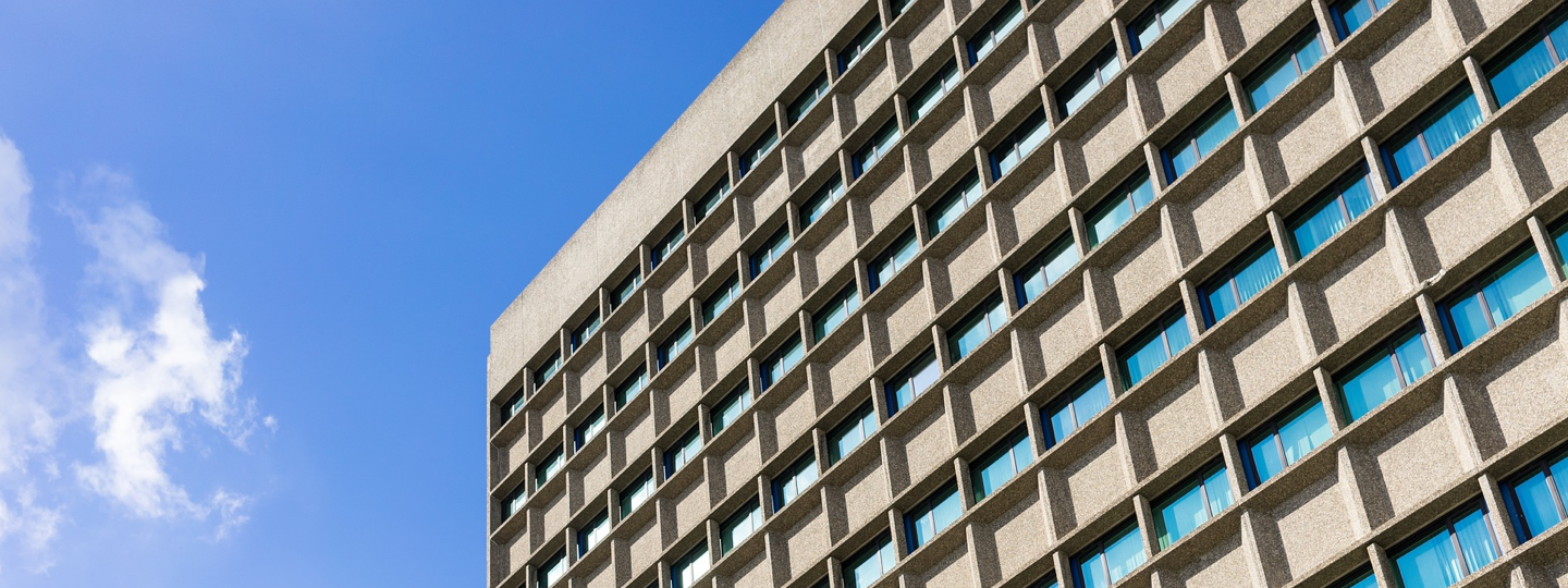 The side of a concrete and glass office building