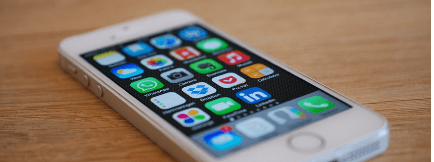 Closeup of a white iPhone on a wooden table