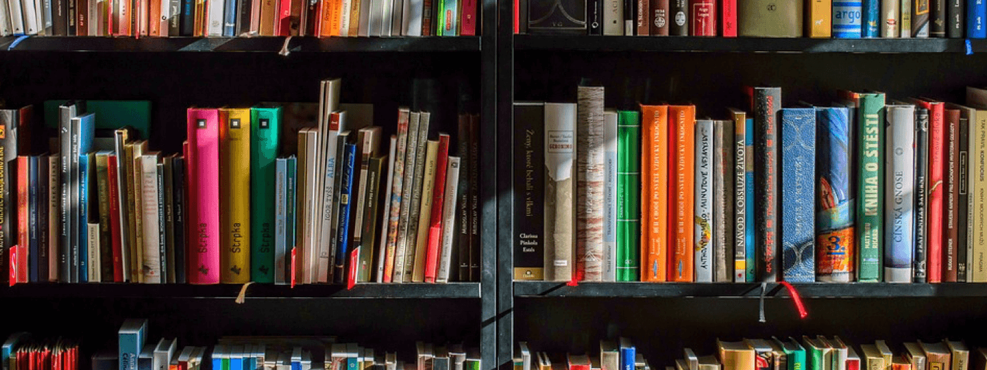 A bookshelf filled with brightly colored books