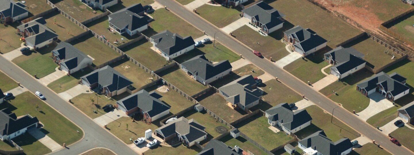 Aerial view of a tree-less suburban neighborhood