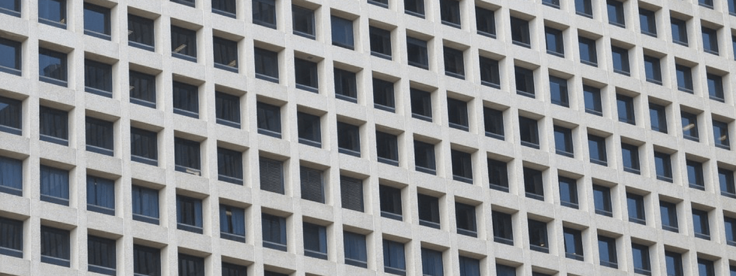 The facade of a large concrete and glass building