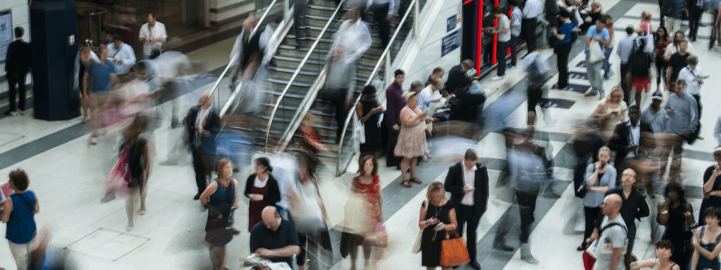 A blurry inside view of a crowded mall