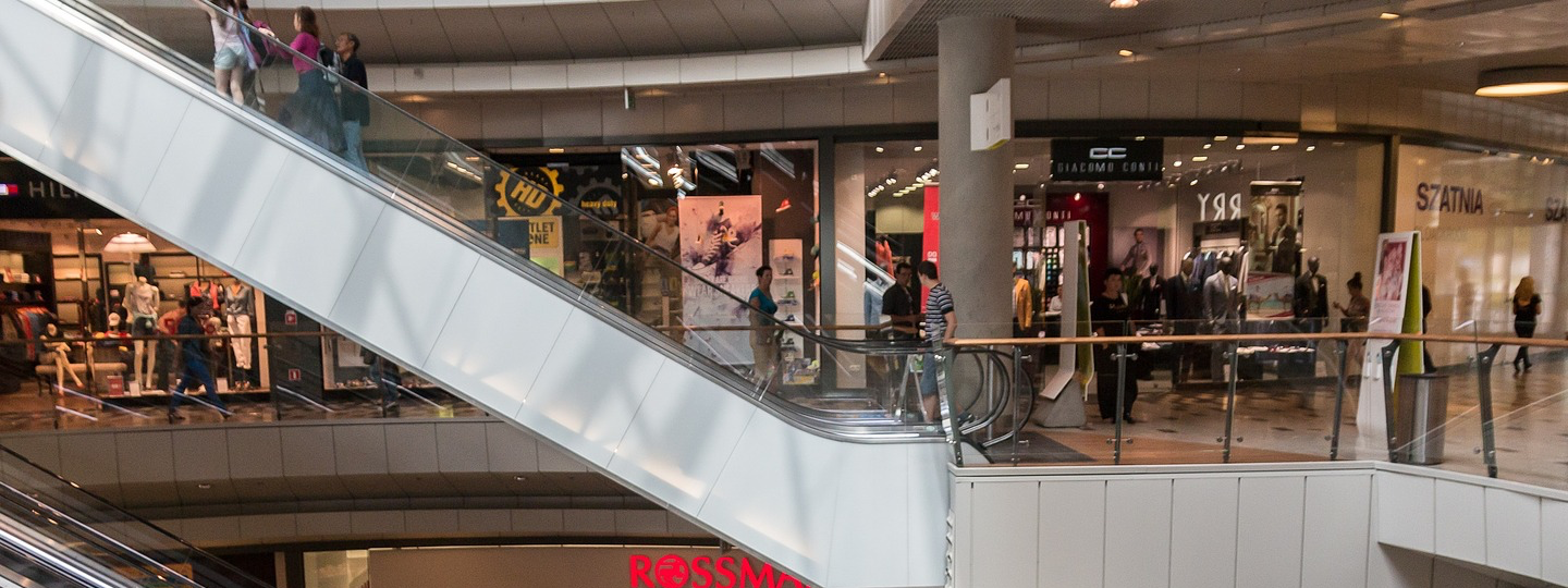 An escalator inside a multi-story mall