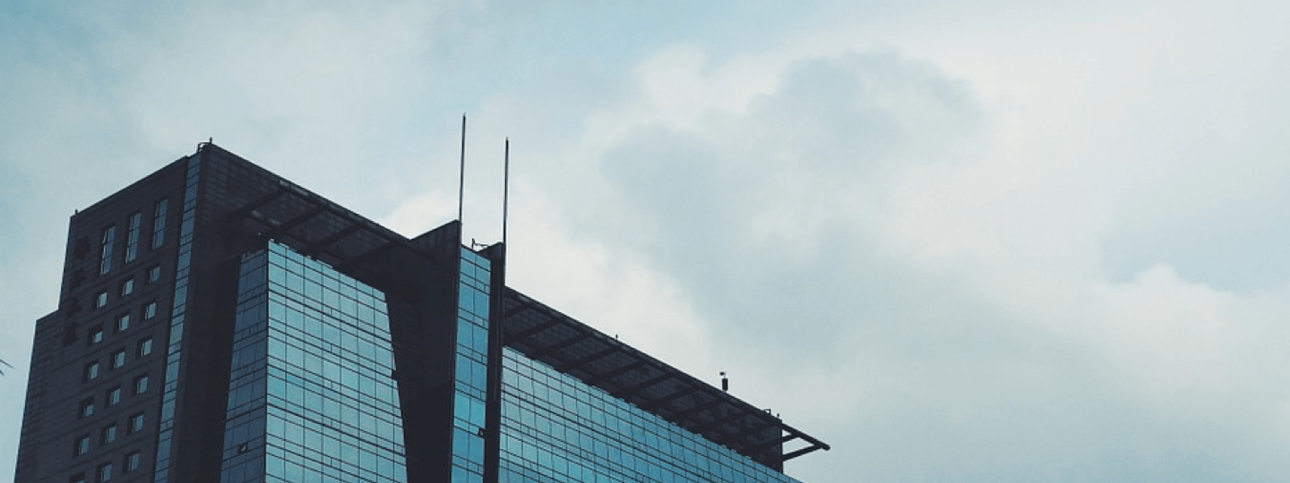 The top of a large office building on a cloudy day