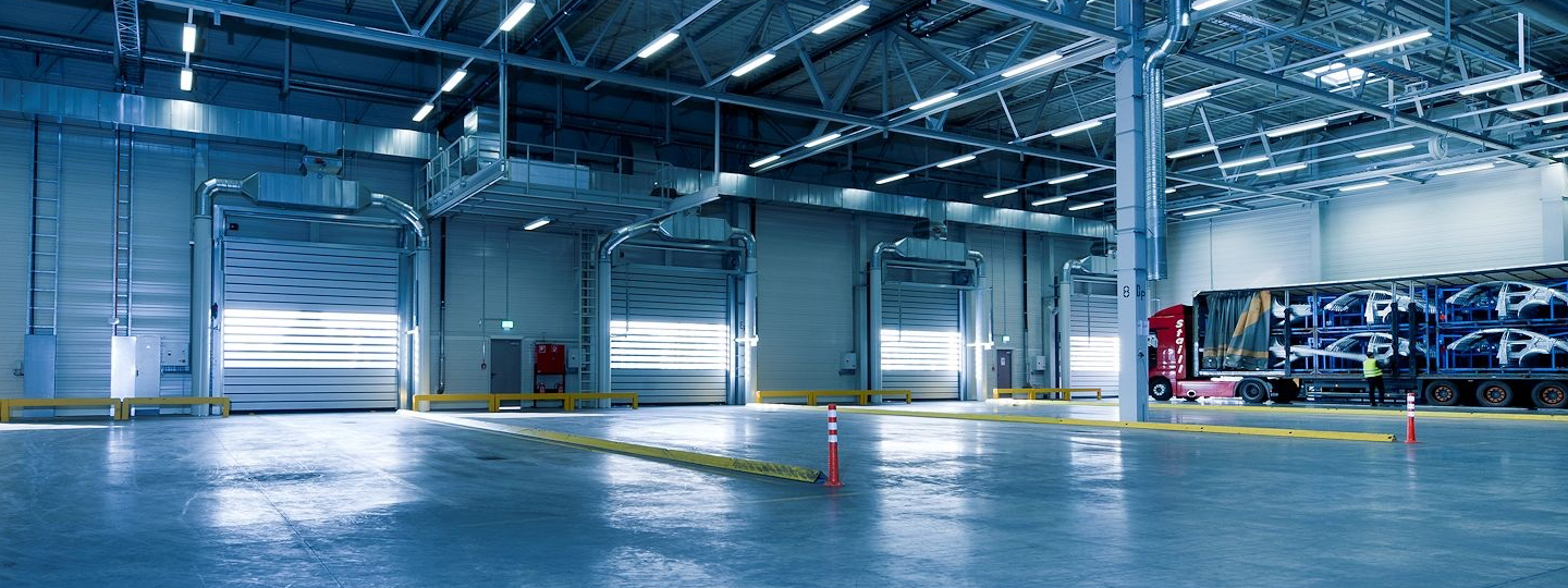 Inside a large warehouse looking towards 4 loading bays