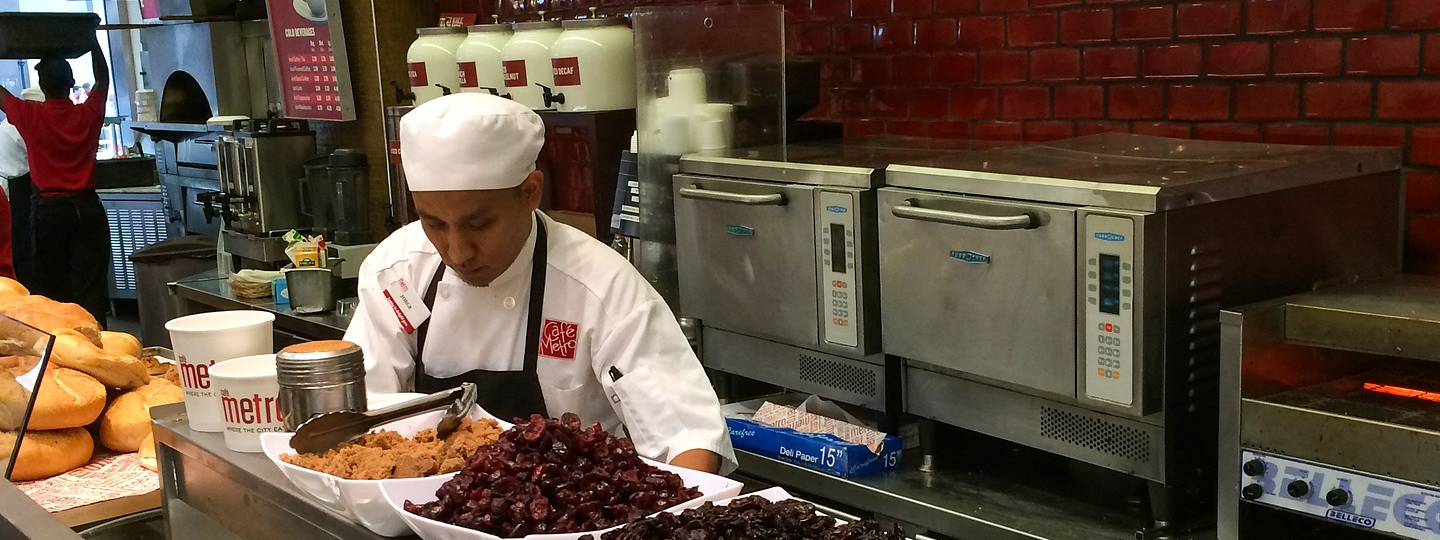 A cook preparing food at Cafe Metro