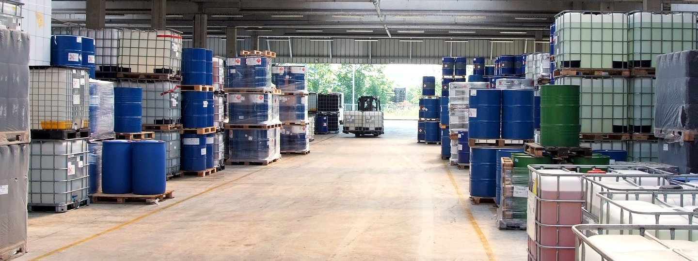 Interior view of a warehouse with pallets and barrels