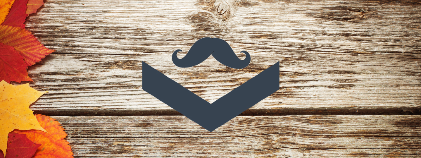 A logo with a mustache overlaid on a wood table