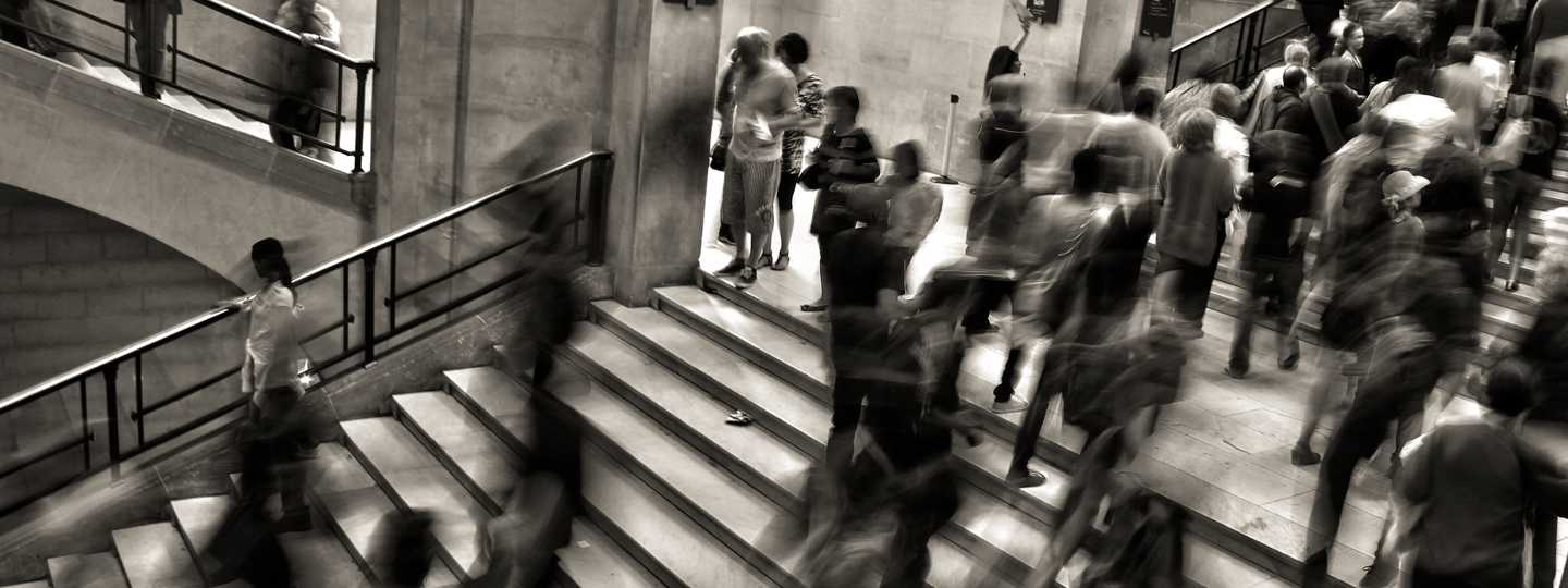 Blurry figures walking up and down a staircase