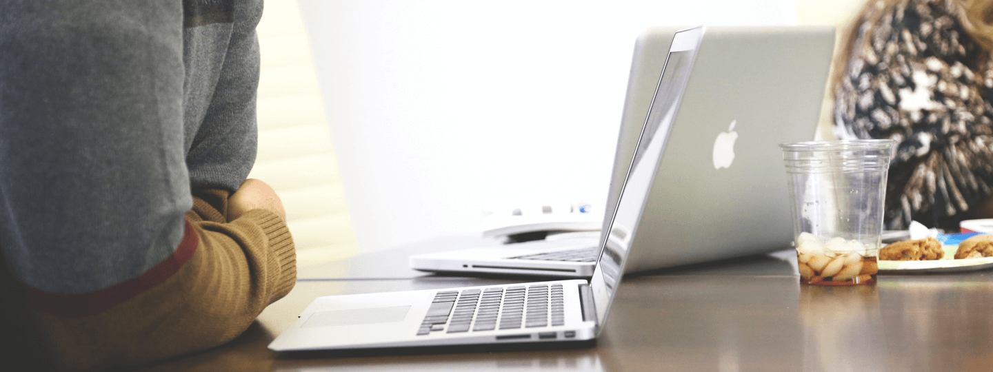 A person working on their laptop at a table