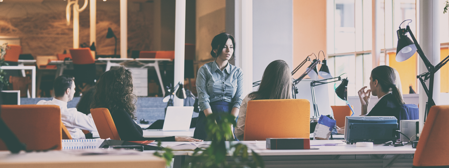 Four female employees collaborating inside an office space