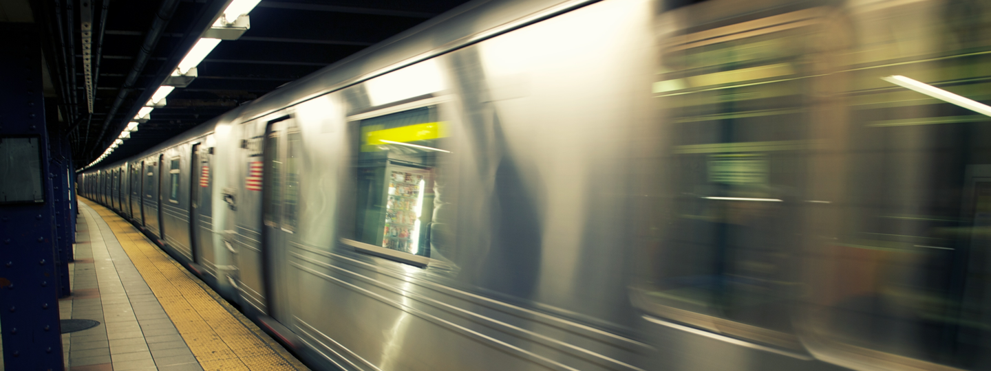 A subway speeds by a subway stop