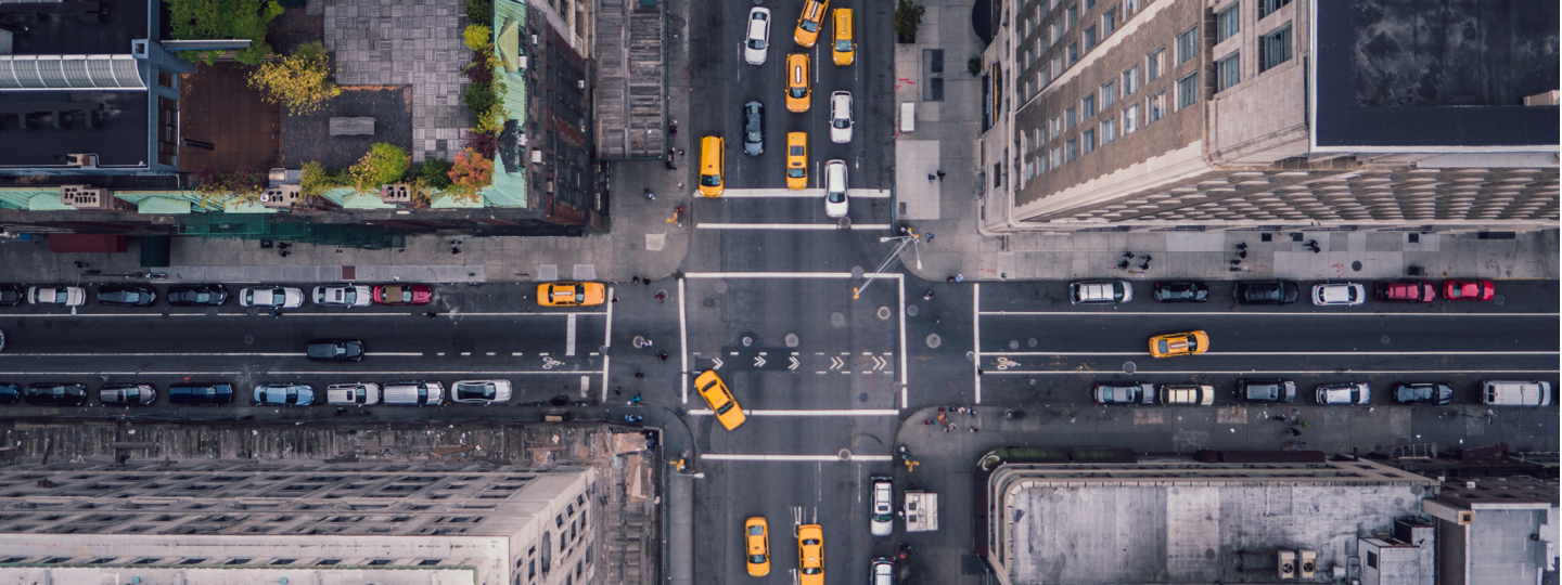 Aerial view of a city intersection with several yellow cabs