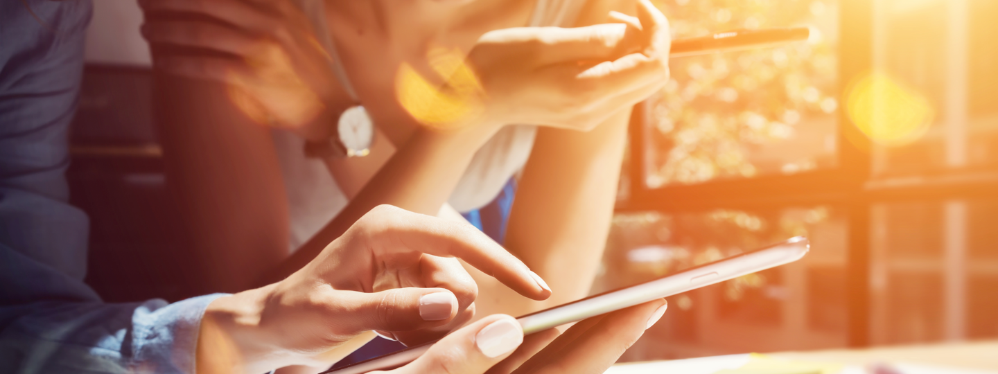 Closeup of two people browsing their phones