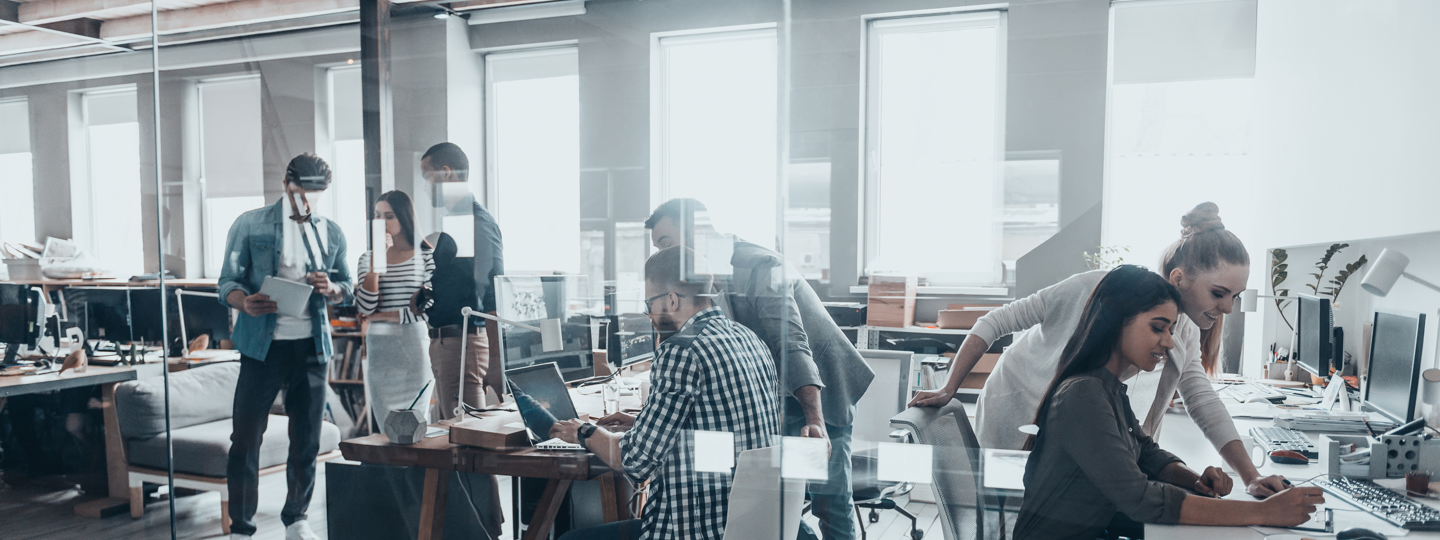 Several young employees working together in a modern office space