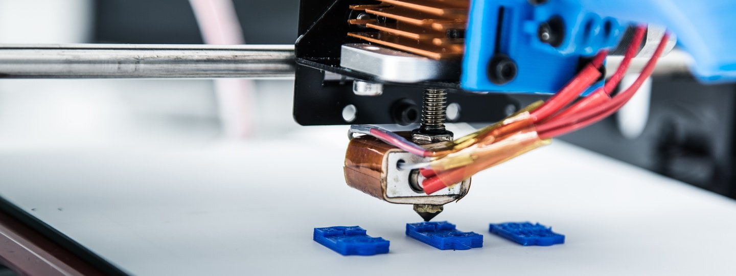 A 3D printer working on three objects