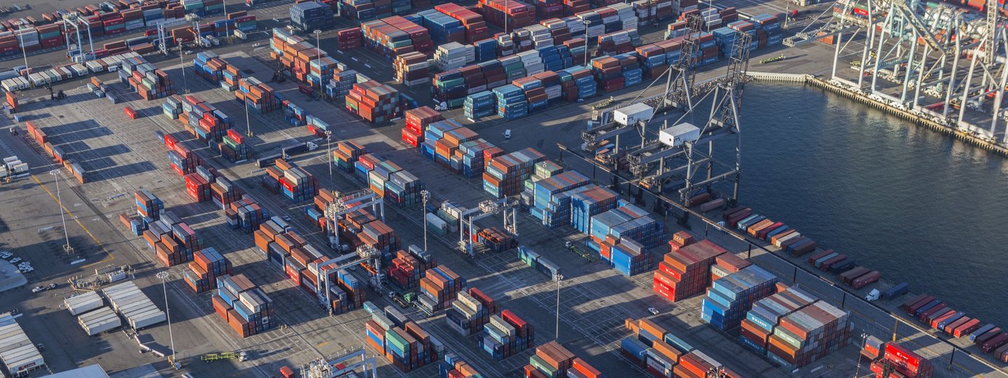 Thousands of shipping containers sit on a very large sea port