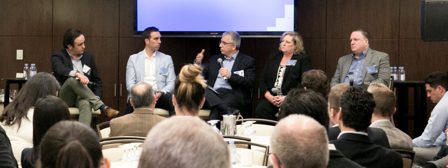 A male panelist speaking at a conference