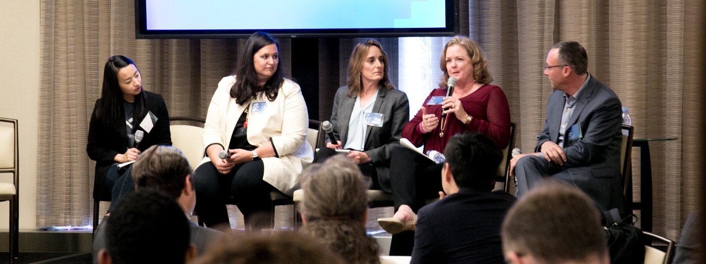 A female panelist speaking at a conference