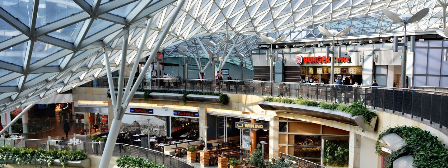 A food court inside a large, multi-story mall