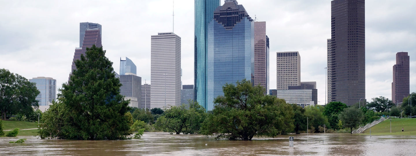 A flooded Buffalo Bayou and the Houston skyline