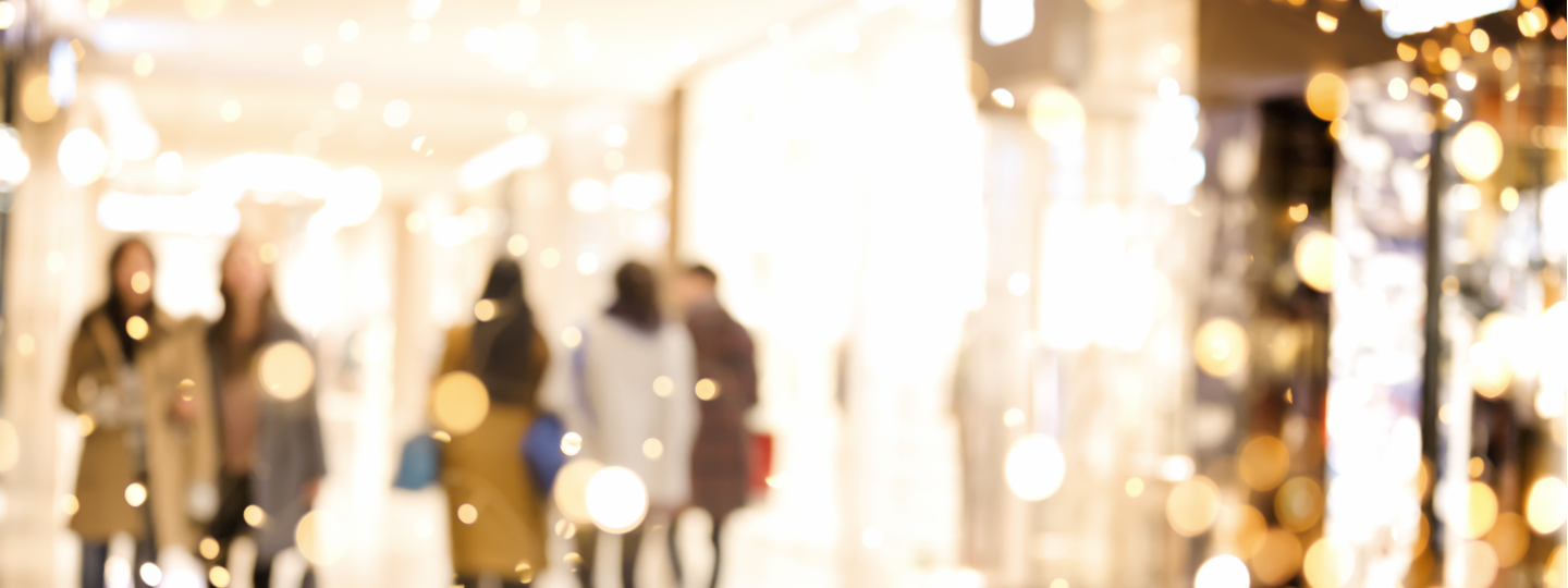 Out of focus and over saturated view of people in a mall