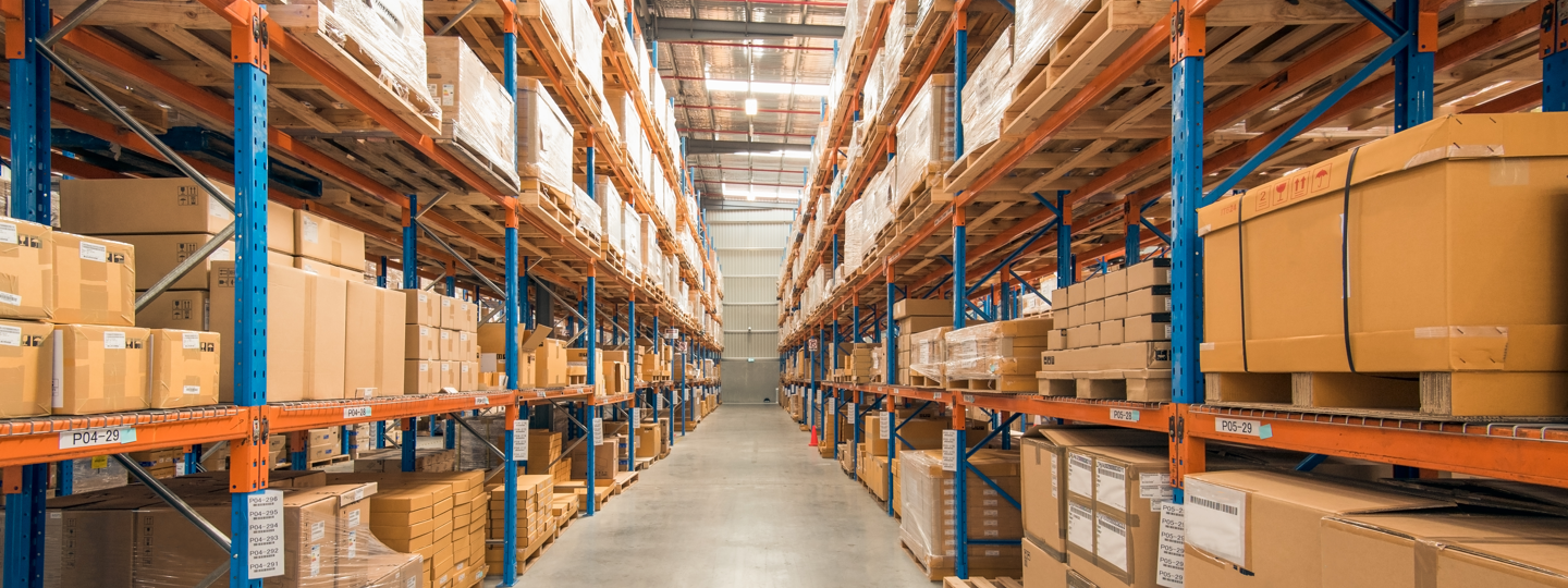 Inside a large warehouse full of pallets and boxes on racks