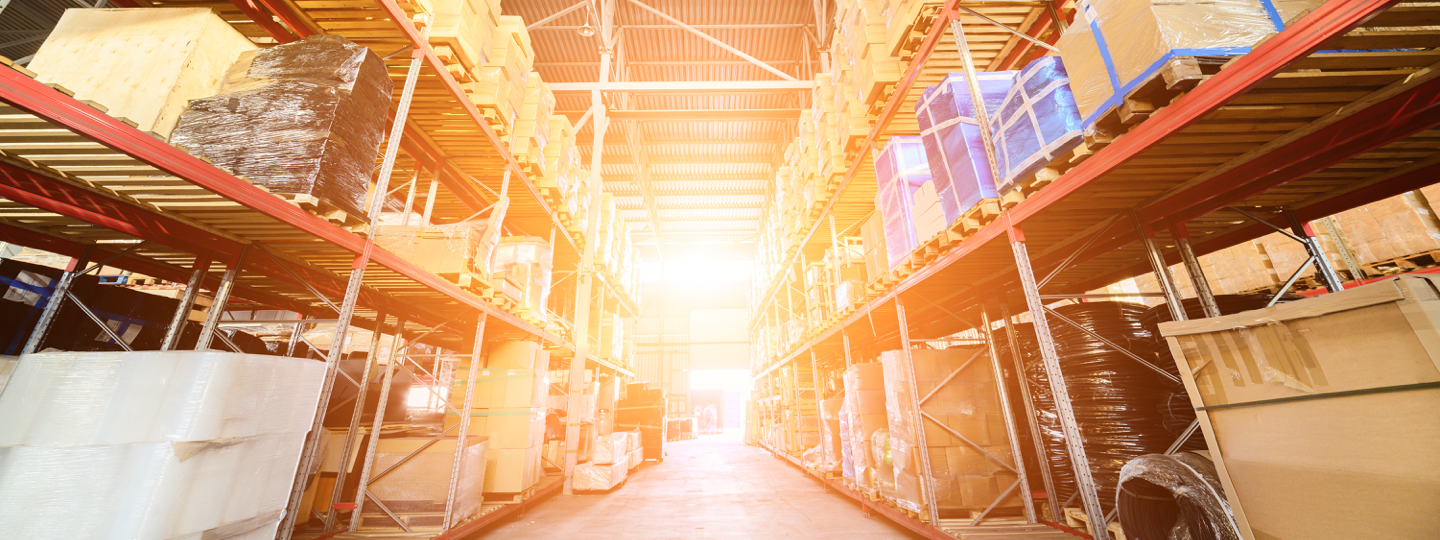 Inside a large warehouse with shelves of boxes and equipment