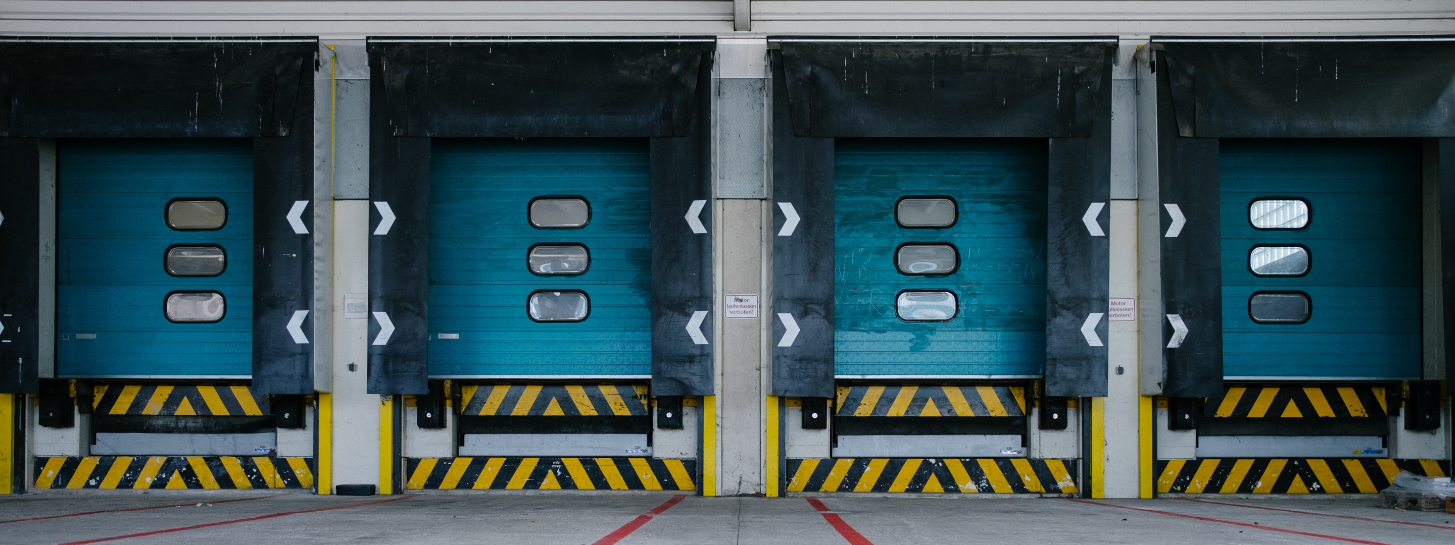 A view of four loading docs with blue doors