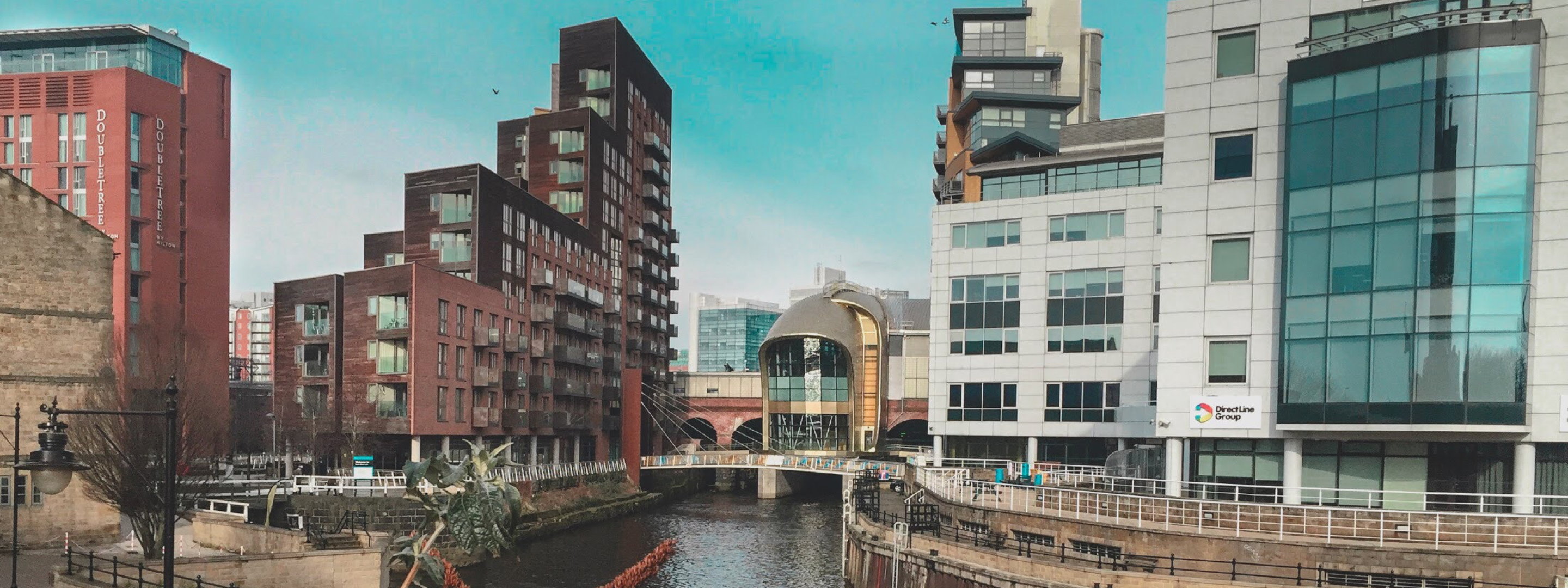 A small waterway winds through office and residential buildings